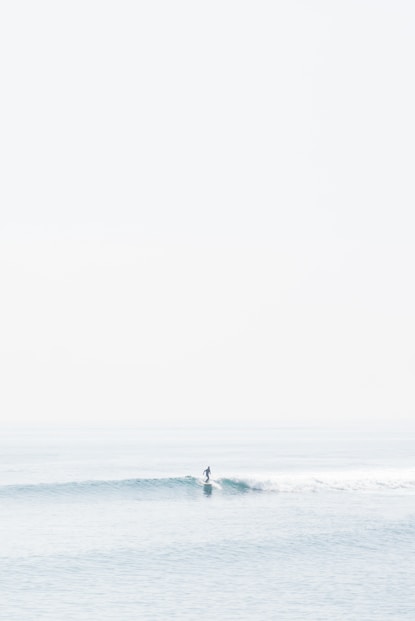 person surfing on sea waves during daytime