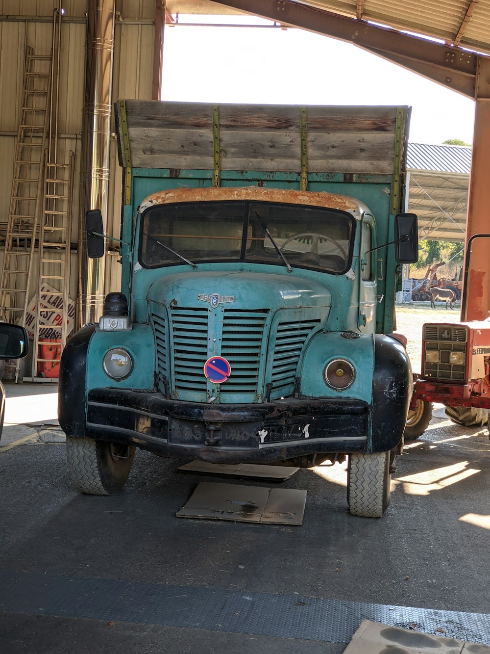 blue vintage car parked on gray asphalt road during daytime