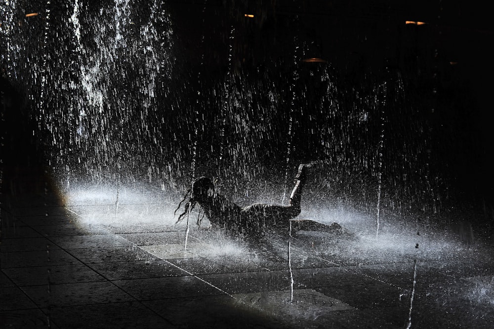 silhouette of people playing on water fountain
