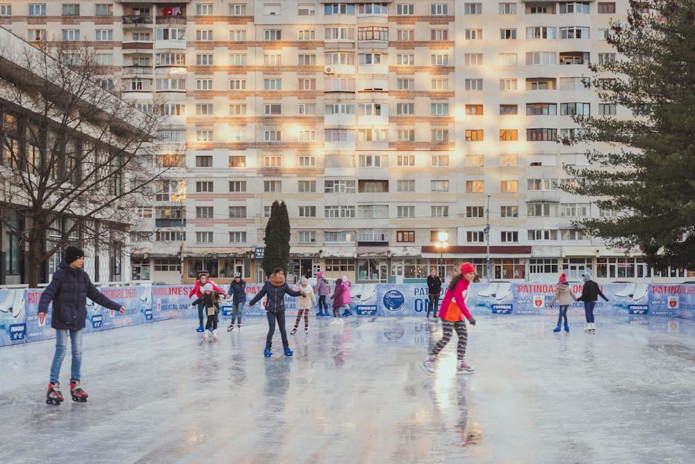 people playing ice hockey on ice field during daytime