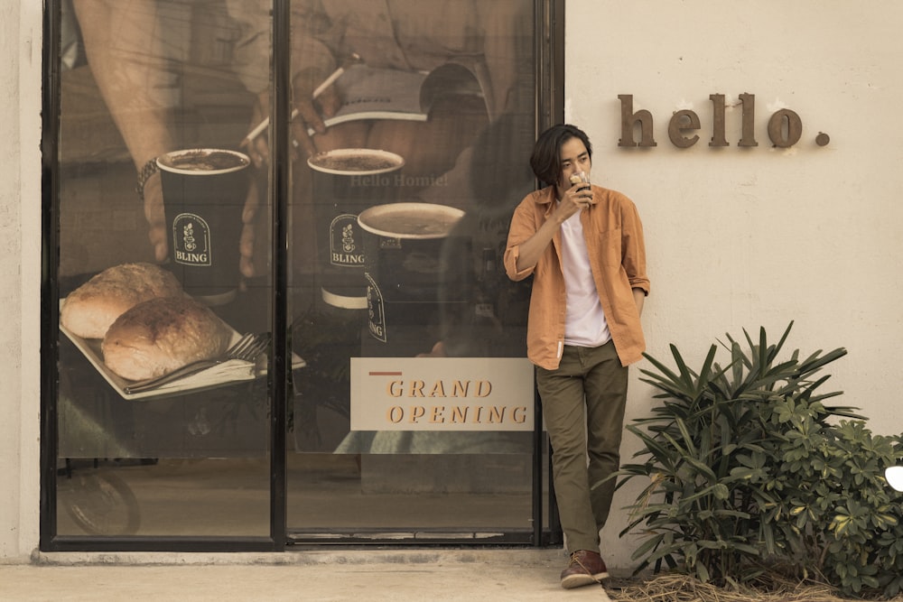 woman in yellow coat standing beside glass window