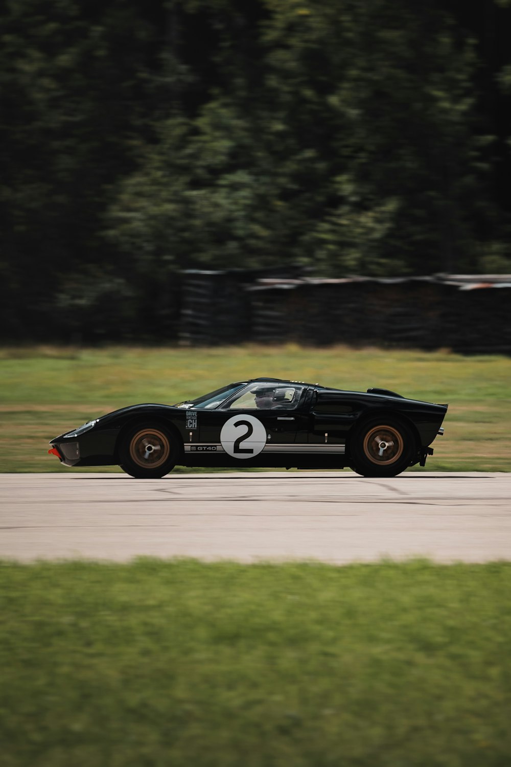 black coupe on gray asphalt road during daytime