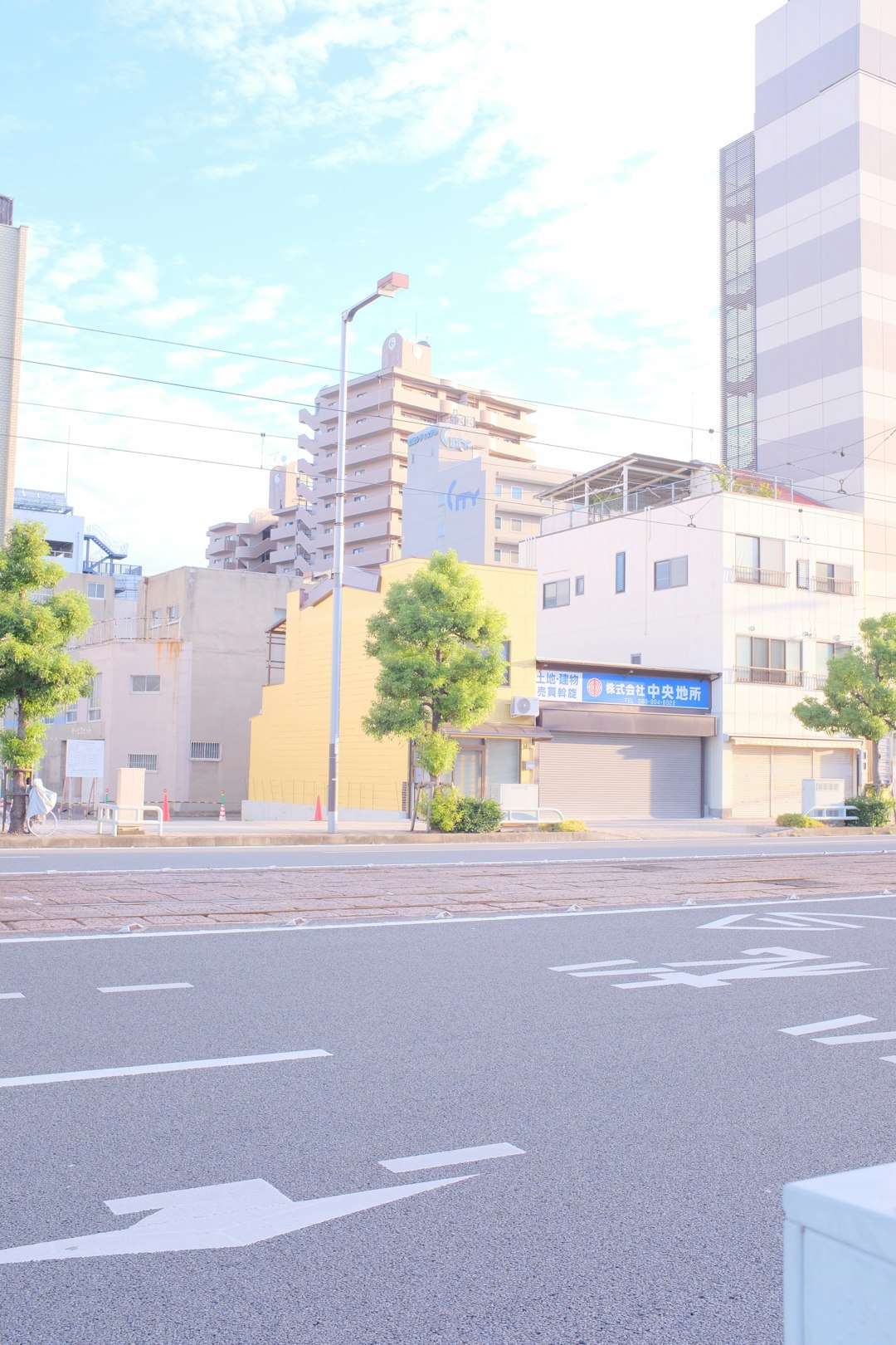 yellow and blue concrete building beside gray asphalt road during daytime