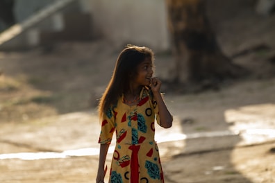 Smiling girls in colorful dresses enjoying a sunny day outside