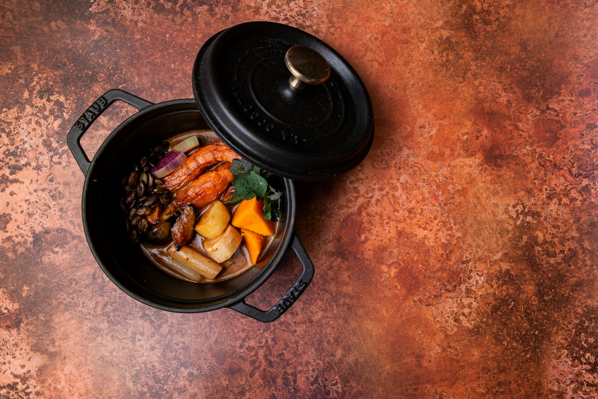 Black cooking pan with food on a stove