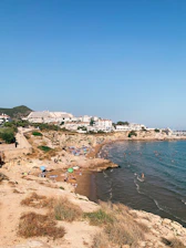 A scenic view of Constanța's coastline with tourists enjoying the beach.