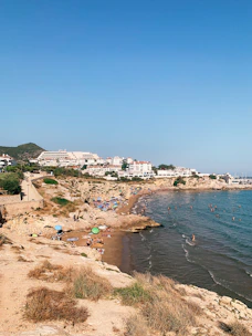 A scenic view of Constanța's coastline with tourists enjoying the beach.