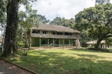 Dormitory building surrounded by lush green trees at the pesantren.