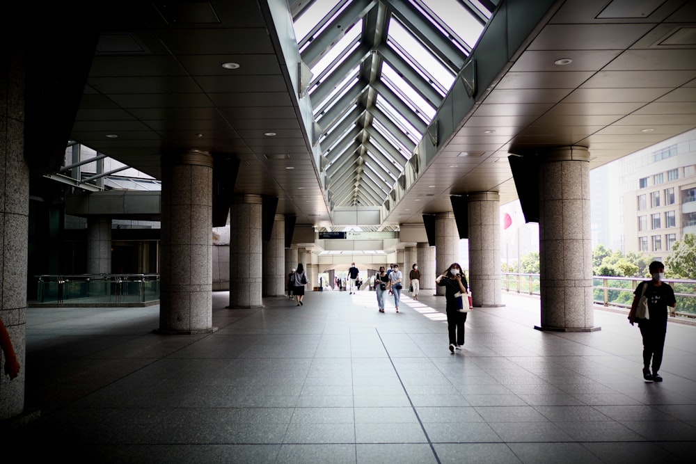 people walking on white tiled floor