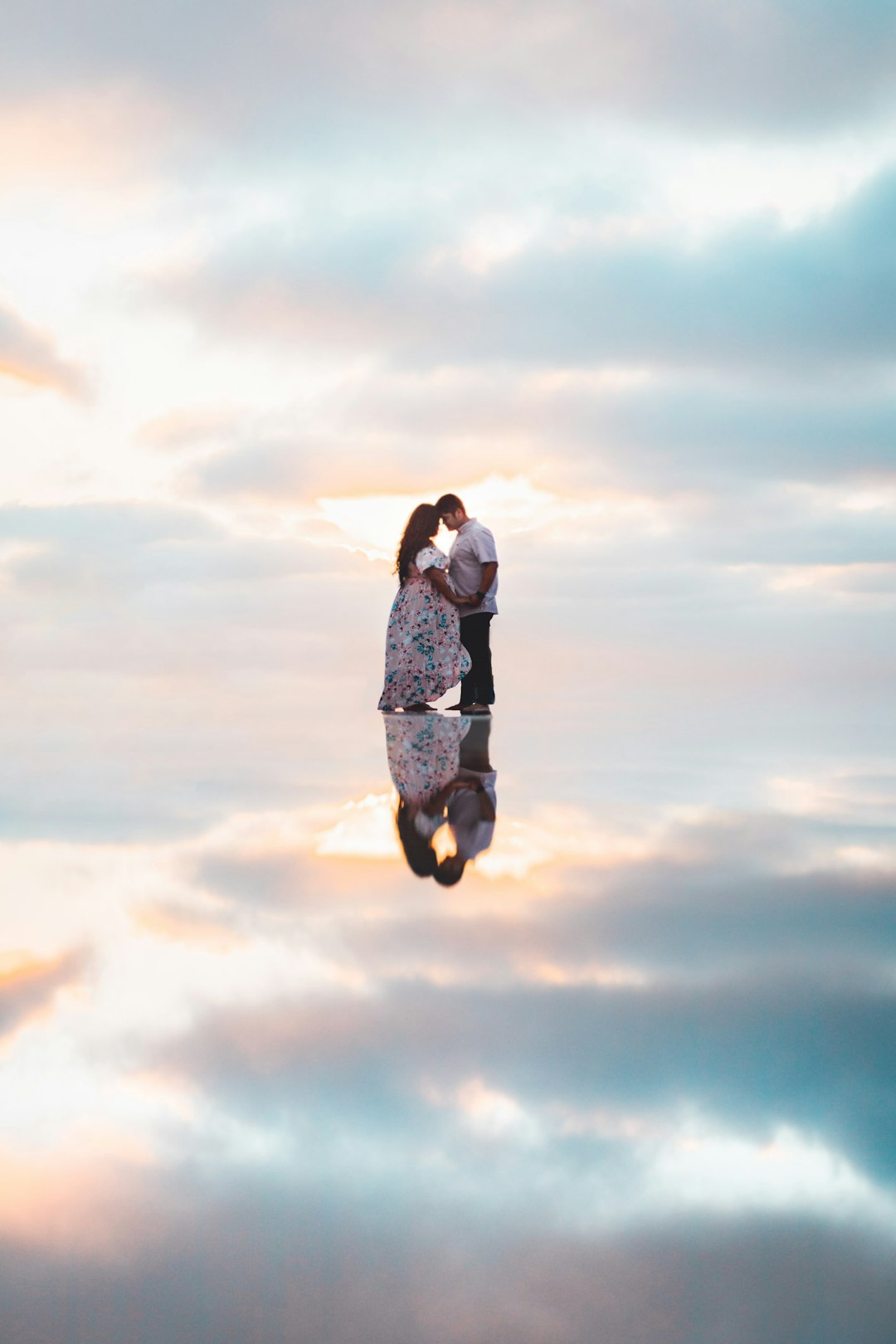 woman in black and white floral dress standing under white clouds during daytime