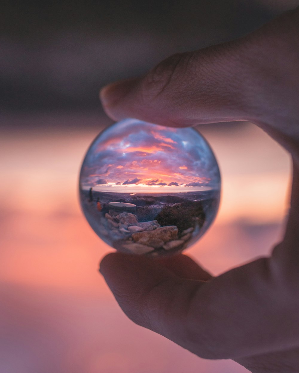 person holding clear glass ball