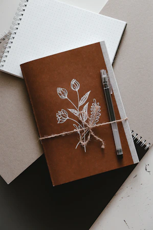 brown and white book on white paper