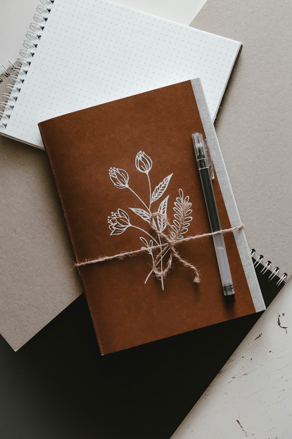 brown and white book on white paper