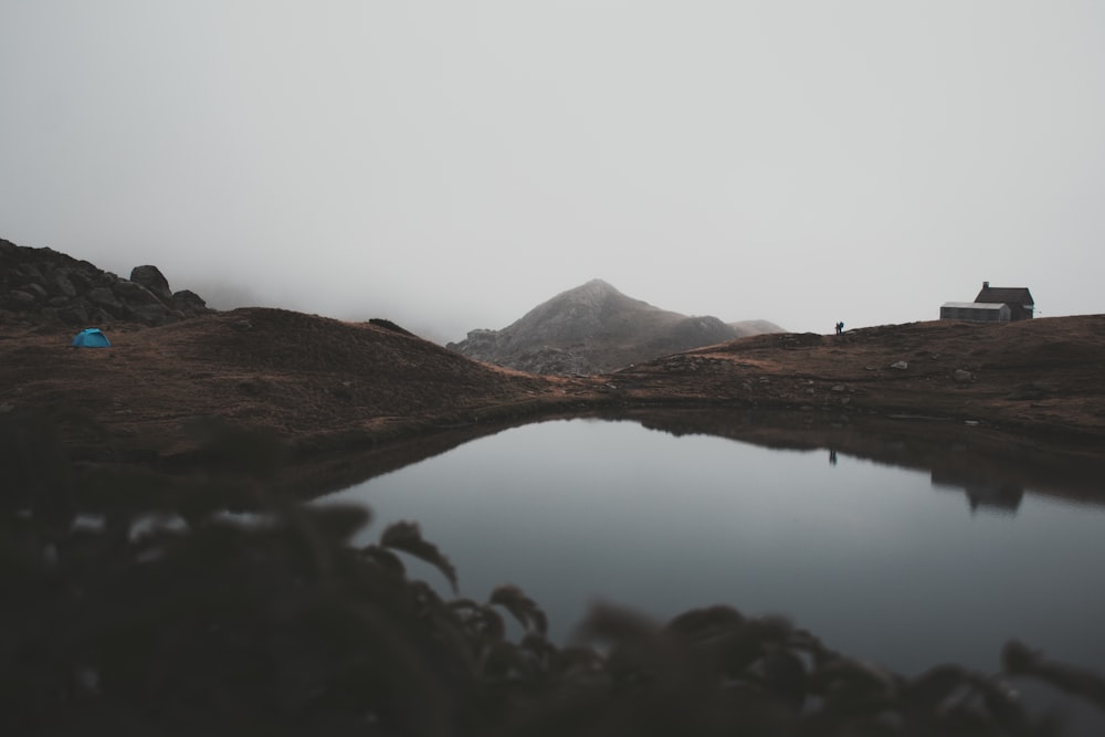 brown mountain near body of water