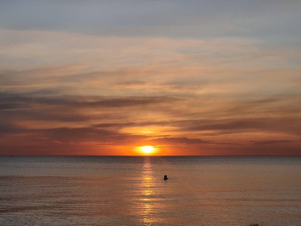 body of water during sunset