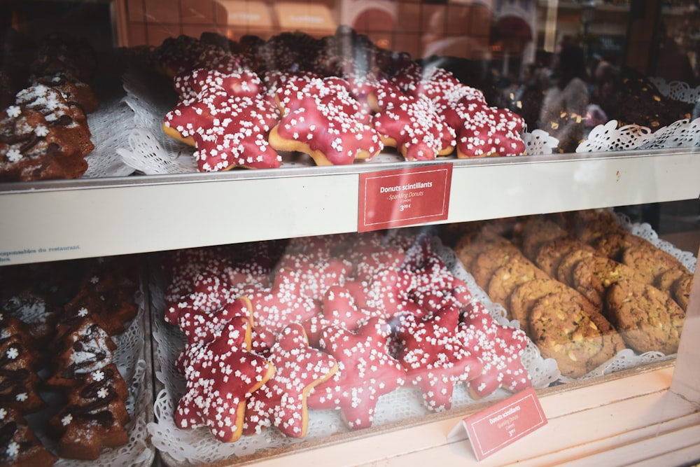 assorted doughnuts on white wooden shelf