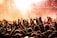 people raising their hands on concert