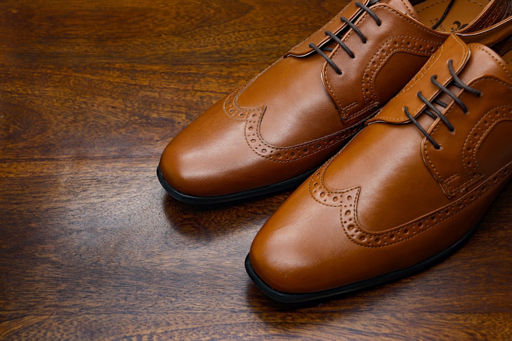 brown leather shoes on brown wooden floor