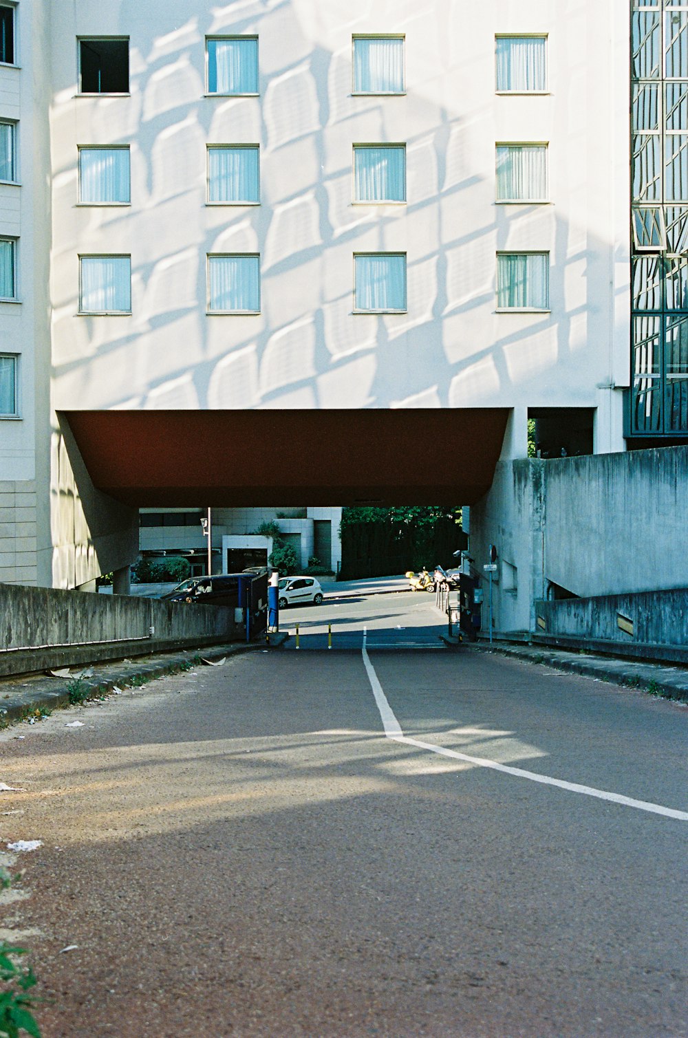 man in white shirt and black pants walking on sidewalk during daytime