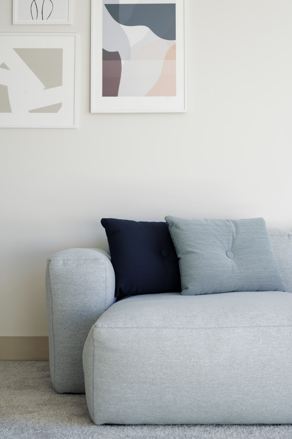 white throw pillow on white couch