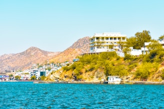white and brown concrete building near body of water during daytime