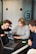A collaborative workspace with multiple people analyzing 3D models on screens.