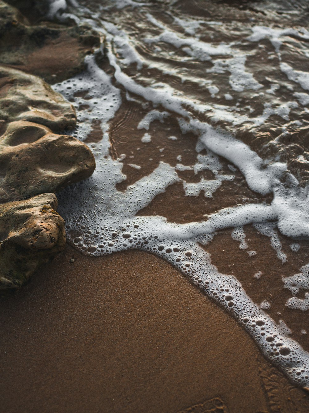 brown rock formation on brown sand