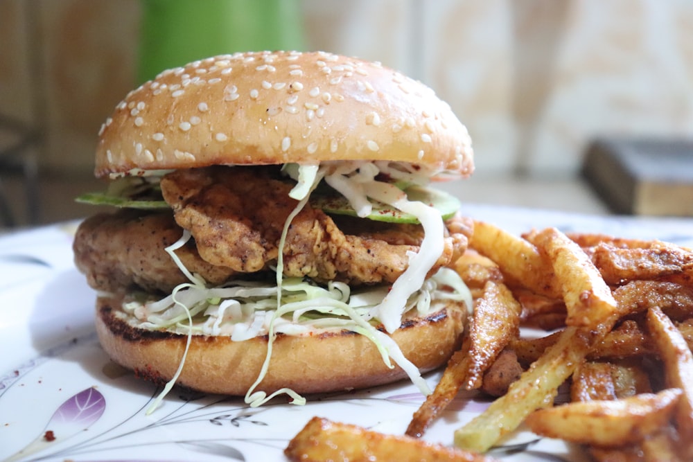 burger with lettuce and fries on white ceramic plate