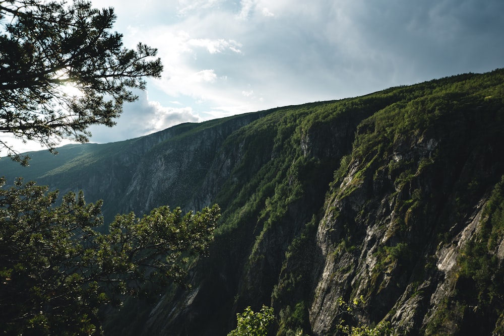 green and gray mountain under white clouds during daytime