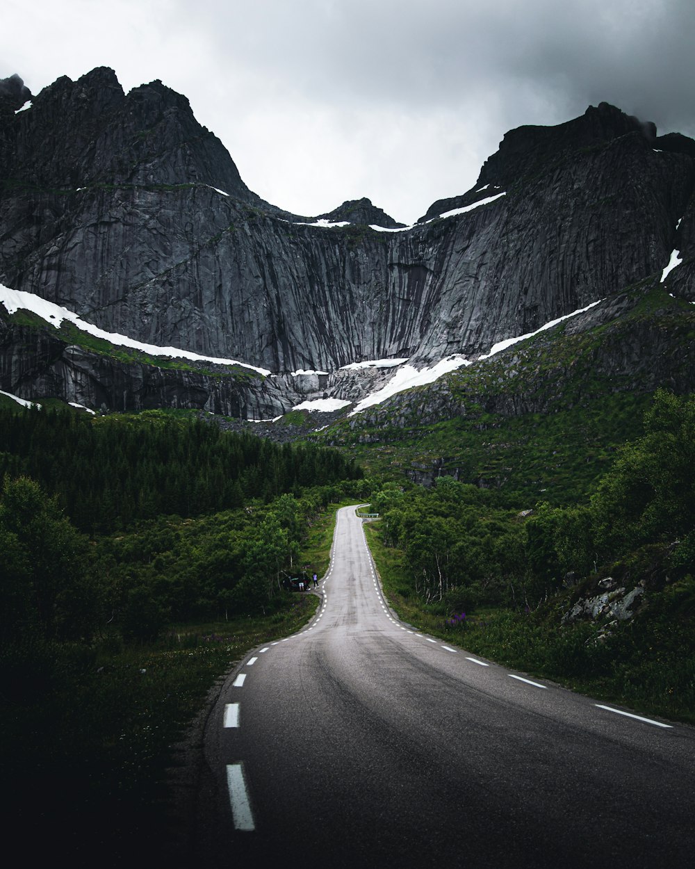 gray concrete road near mountain