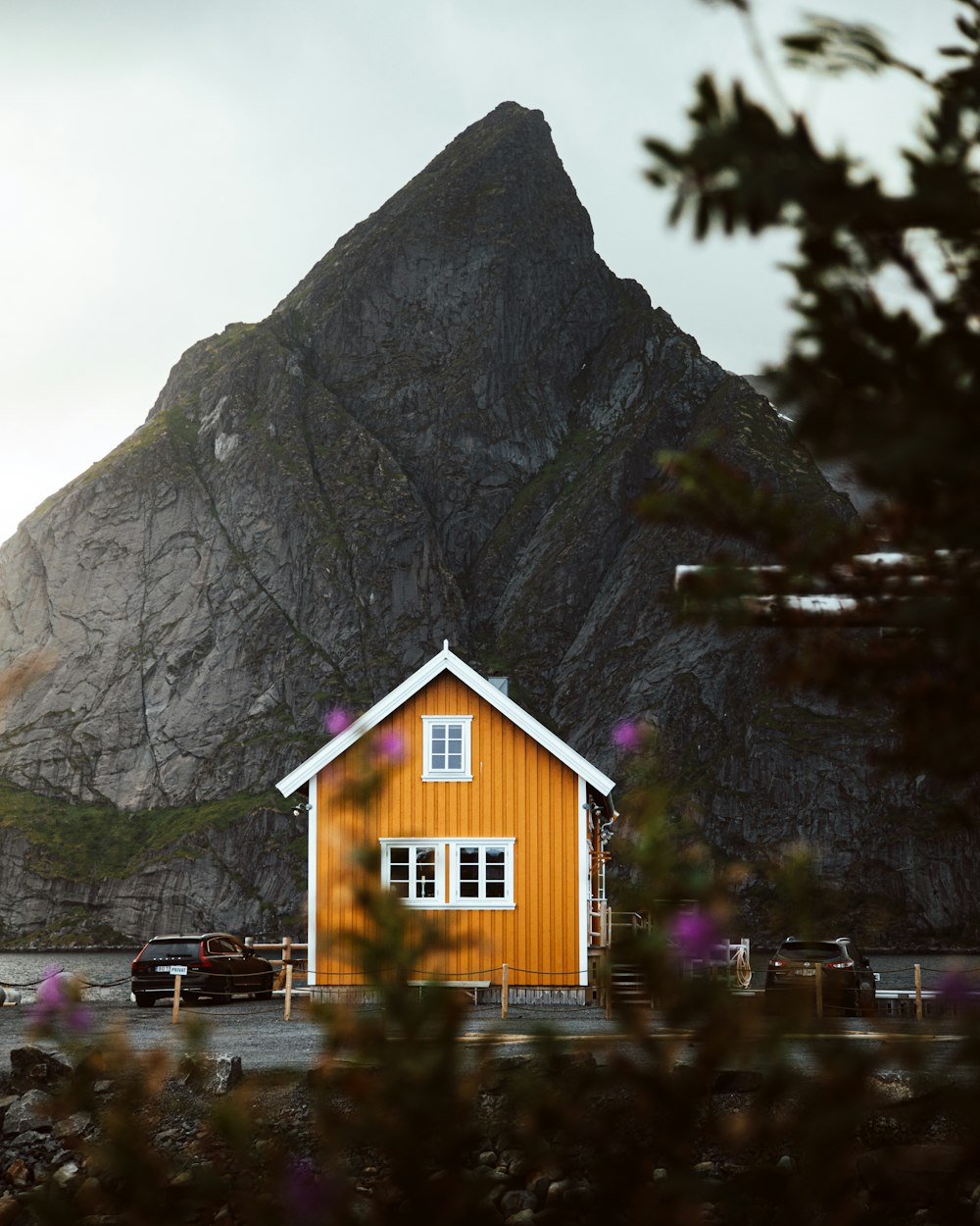 brown wooden house near mountain during daytime