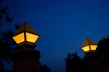 Warm glow from lanterns lighting the entrance to the ranch at twilight.