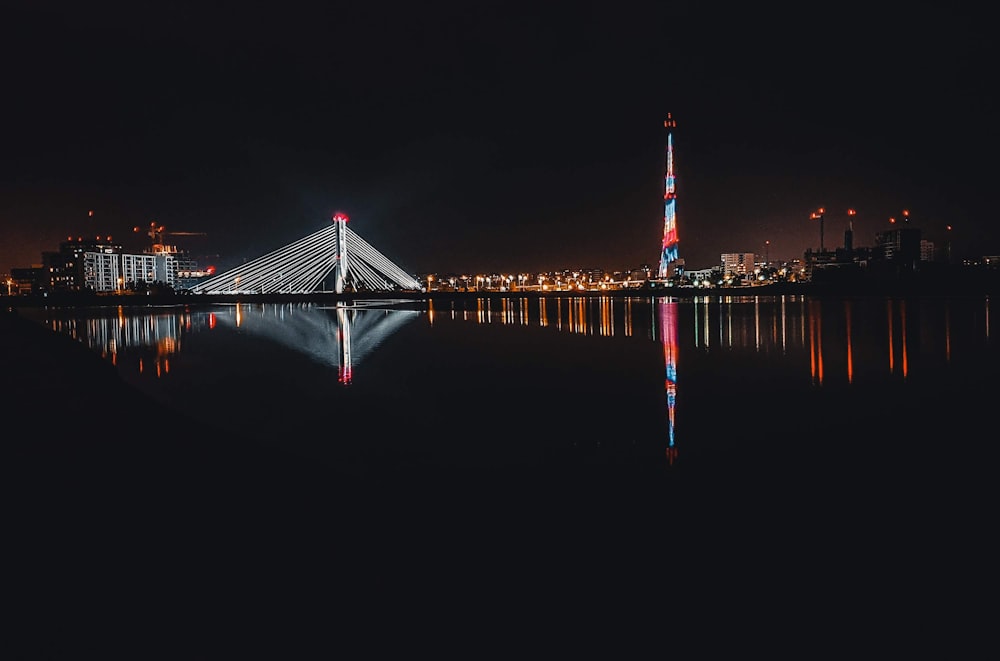 red and white bridge during night time