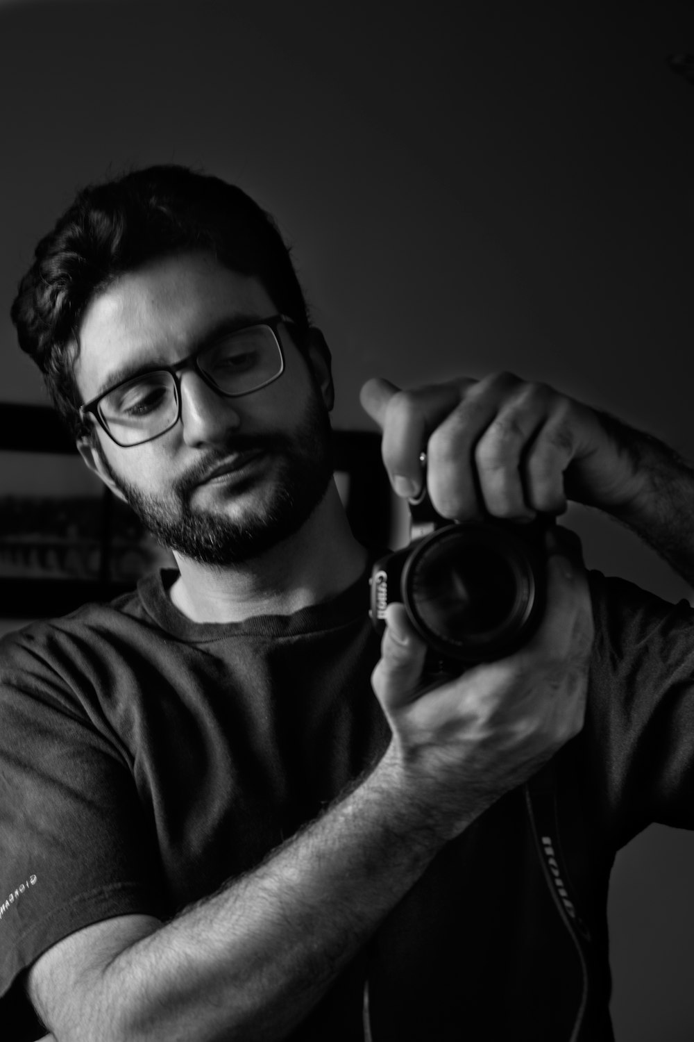 man in black framed eyeglasses holding camera