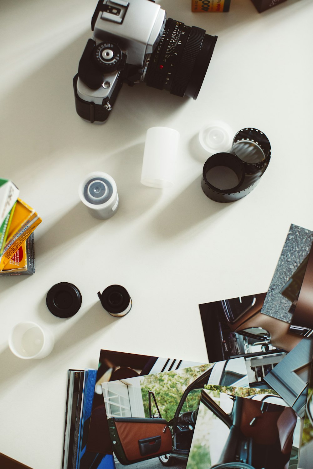 black and silver camera lens on white table