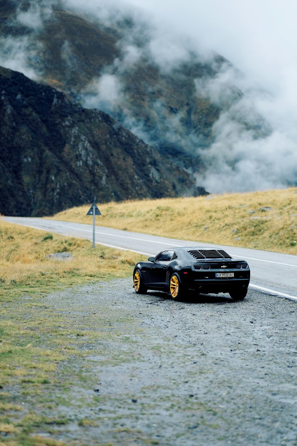 black chevrolet camaro on road during daytime