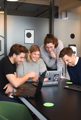 people sitting on chair in front of laptop computers