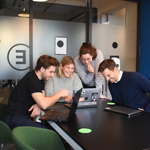 people sitting on chair in front of laptop computers