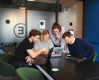 A smiling group of diverse writers chatting during a virtual Zoom meeting.