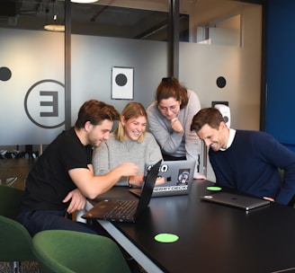 people sitting on chair in front of laptop computers