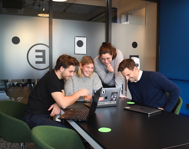 people sitting on chair in front of laptop computers