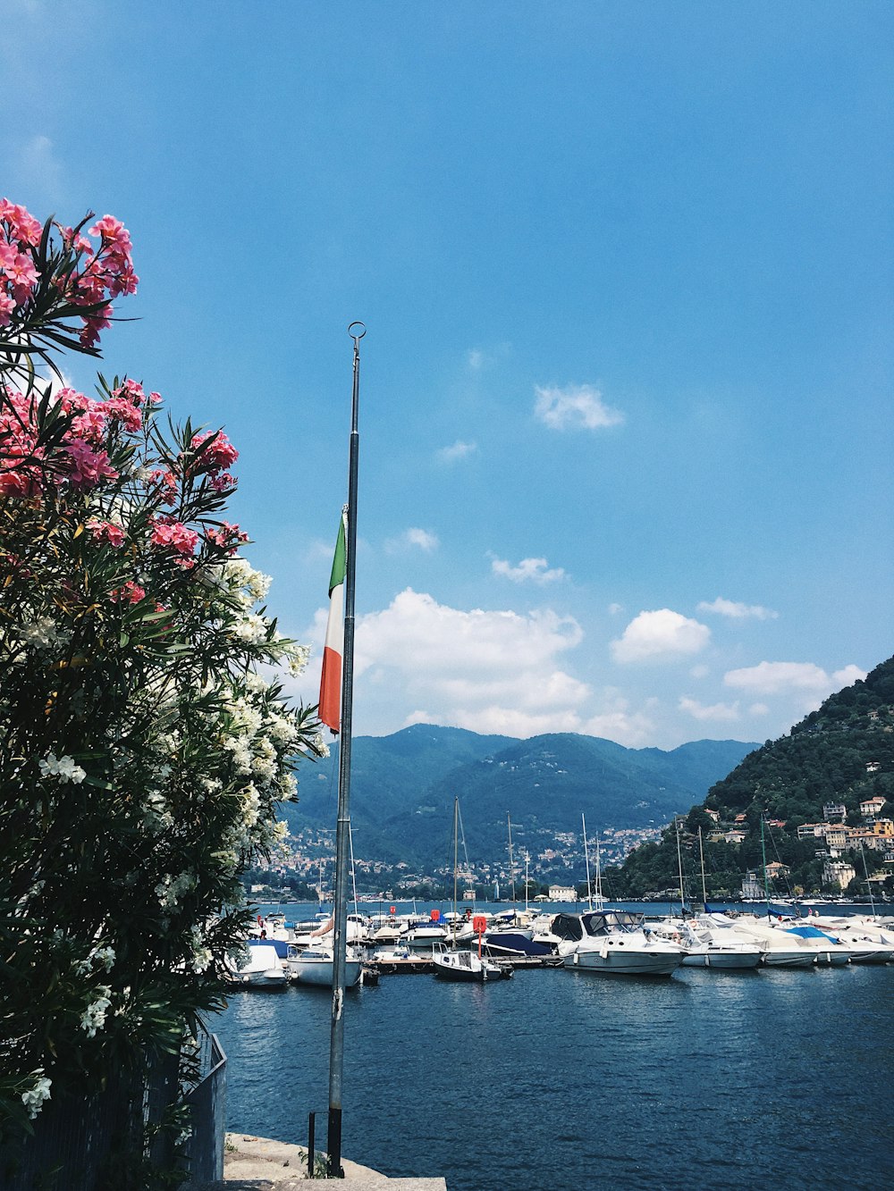 white boat on body of water near mountain during daytime