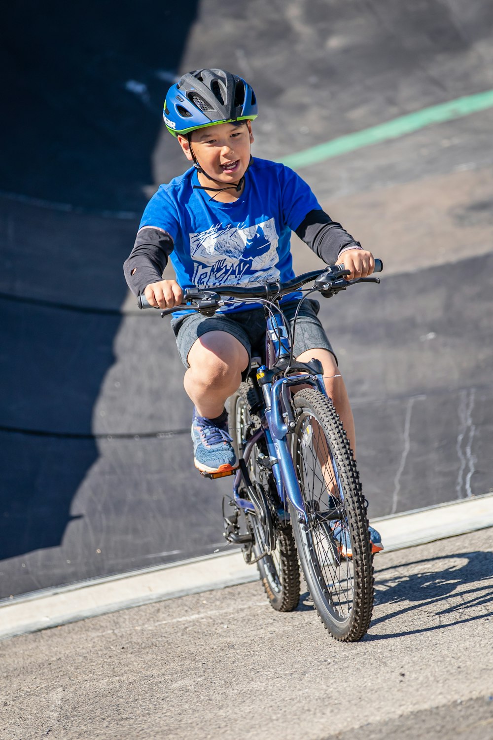 boy in blue long sleeve shirt riding on bicycle