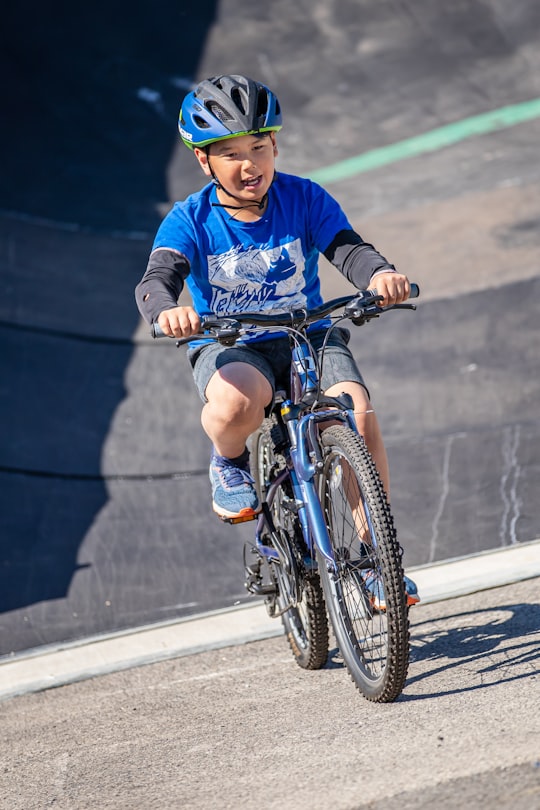 boy in blue long sleeve shirt riding on bicycle in Donegal Town Ireland