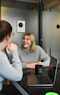 woman in gray sweater sitting beside woman in gray sweater