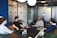 A professional team discussing safety protocols in a modern office environment.