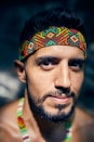 man in green tank top wearing orange and blue bandana