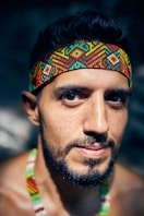 man in green tank top wearing orange and blue bandana
