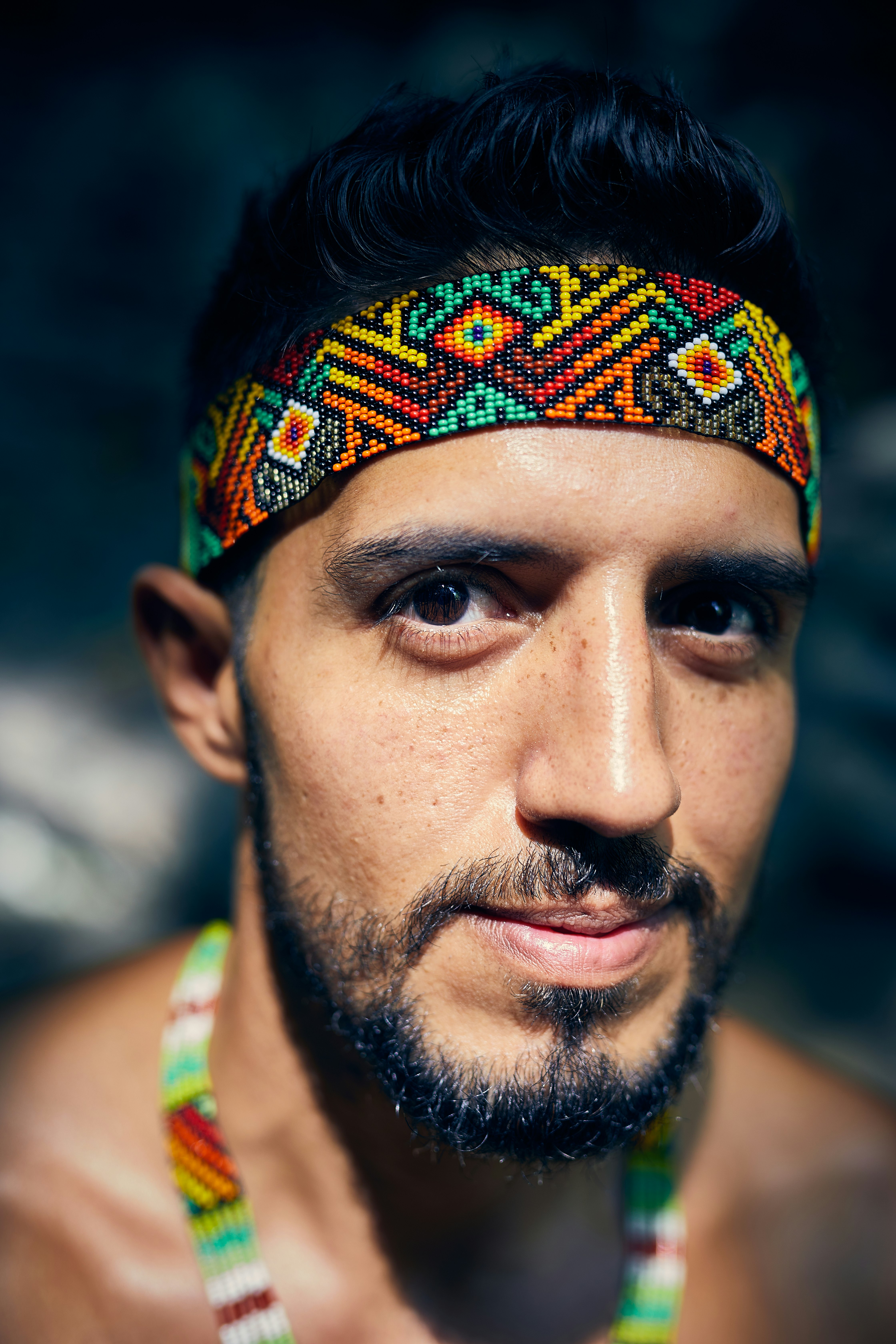 man in green tank top wearing orange and blue bandana