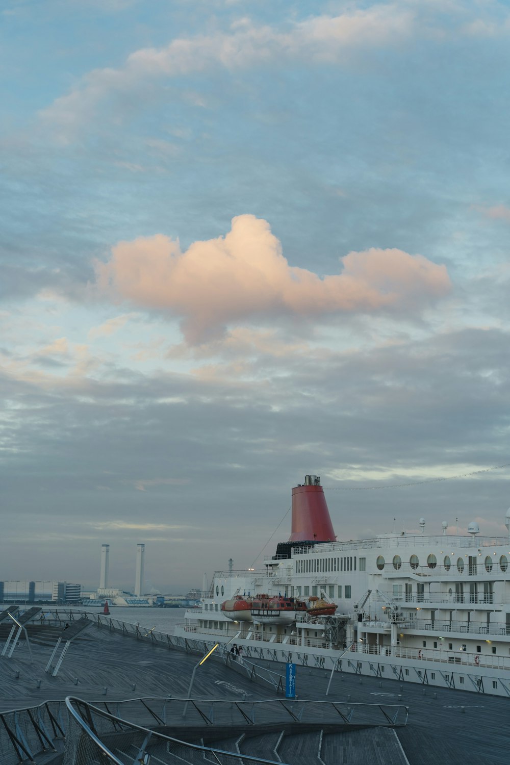 white cruise ship on sea under white clouds during daytime